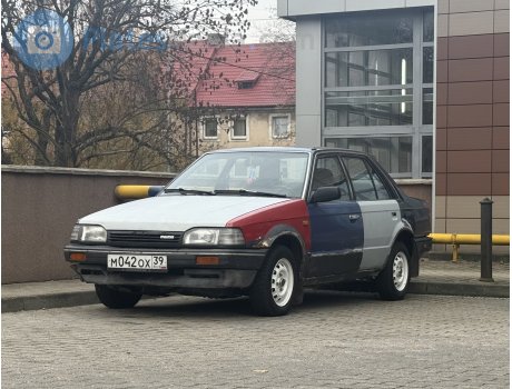 м042ох39, Mazda 323